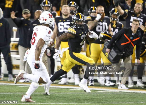 Running back Kaleb Johnson of the Iowa Hawkeyes goes up the field during the second half against defensive back Shaquan Loyal of the Rutgers Scarlet...