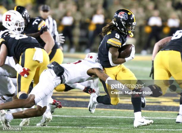 Running back Jaziun Patterson of the Iowa Hawkeyes goes up the field during the second half against defensive back Eric Rogers of the Rutgers Scarlet...