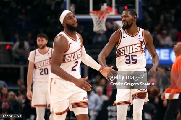 Kevin Durant of the Phoenix Suns celebrates with Josh Okogie in the second half on the way to a 120-106 win over the Detroit Pistons at Little...