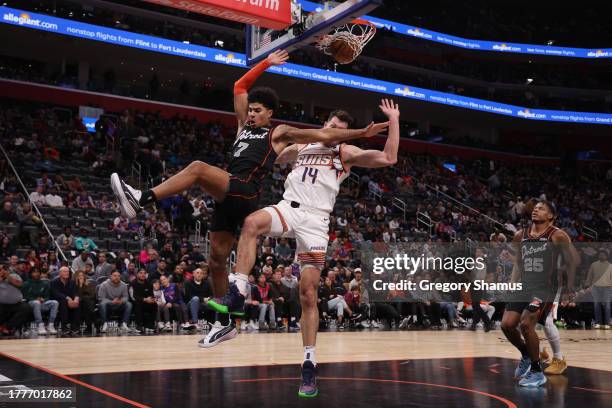 Killian Hayes of the Detroit Pistons makes a layup while being fouled by Drew Eubanks of the Phoenix Suns during the second half at Little Caesars...