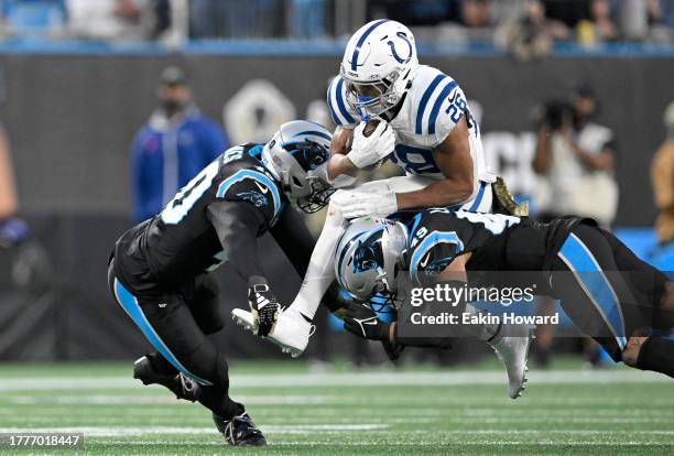 Deion Jones and Frankie Luvu of the Carolina Panthers tackle Jonathan Taylor of the Indianapolis Colts during the second quarter of the game at Bank...