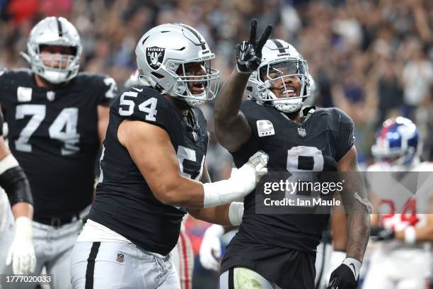 Josh Jacobs of the Las Vegas Raiders celebrates with Netane Muti after a touchdown in the second quarter of a game against the New York Giants at...