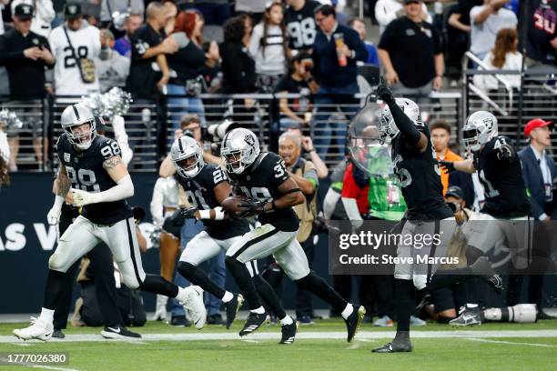 Nate Hobbs of the Las Vegas Raiders reacts after an interception in the second quarter of a game against the New York Giants at Allegiant Stadium on...