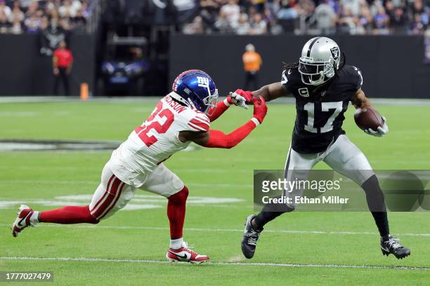Davante Adams of the Las Vegas Raiders runs the ball against Adoree' Jackson of the New York Giants in the second quarter of a game at Allegiant...