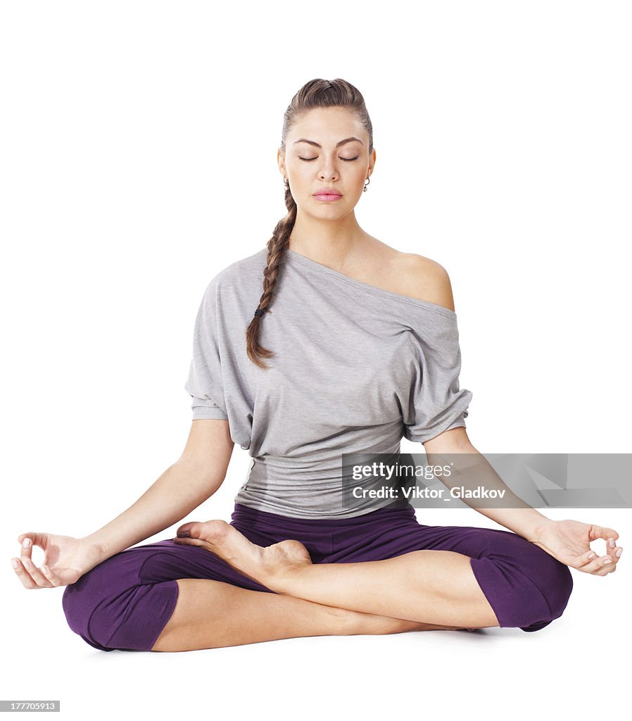 Young woman meditating in Lotus Pose