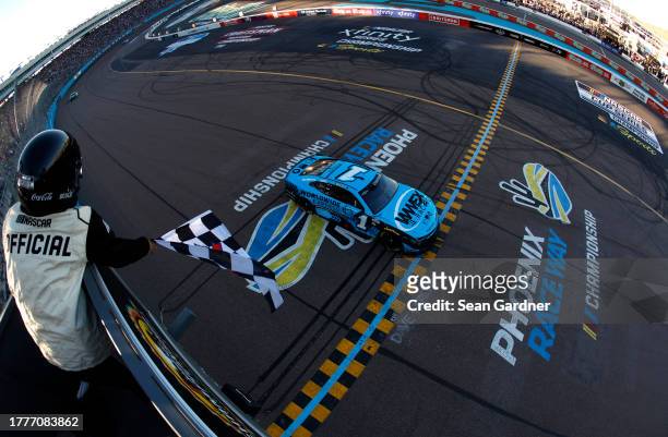 Ross Chastain, driver of the Worldwide Express Chevrolet, takes the checkered flag to win the NASCAR Cup Series Championship race at Phoenix Raceway...