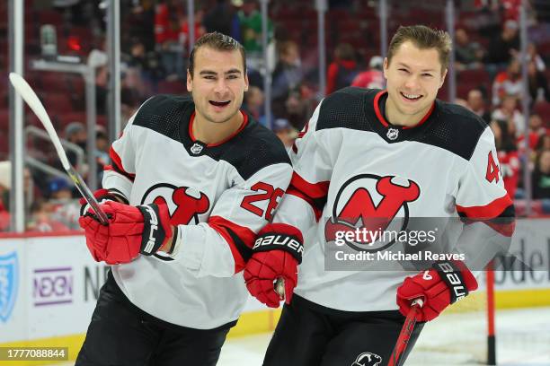 Timo Meier and Curtis Lazar of the New Jersey Devils laugh during warm upsprior to the game against the Chicago Blackhawks at the United Center on...