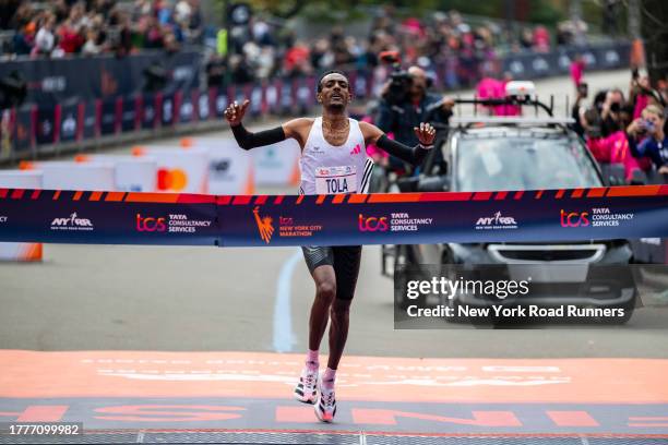 Tamirat Tola of Ethiopia celebrates as crosses the finish line giving him the win in the Men's division and setting a course record during the 2023...