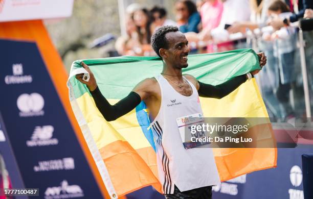 Tamirat Tola of Ethiopia celebrates as crosses the finish line giving him the win in the Men's division and setting a course record during the 2023...