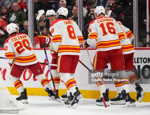 Blake Coleman of the Calgary Flames celebrates his second period goal against the Ottawa Senators with teammates Chris Tanev, Nikita Zadorov, Martin...