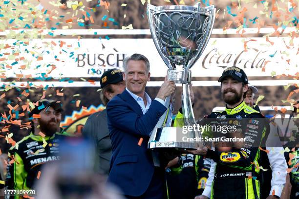 President Steve Phelps presents the Bill France NASCAR Cup Series Championship trophy to Ryan Blaney, driver of the Menards/Dutch Boy Ford, in...