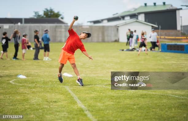 kid putting a shot put in local school games. - shot put stock pictures, royalty-free photos & images