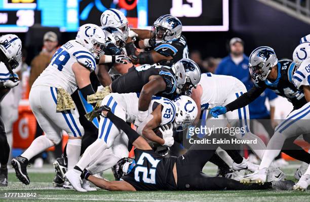 Derrick Brown and Alex Cook of the Carolina Panthers tackle Jonathan Taylor of the Indianapolis Colts during the fourth quarter of the game at Bank...