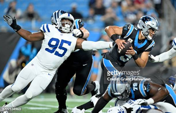 Adetomiwa Adebawore of the Indianapolis Colts sacks Bryce Young of the Carolina Panthers after a scramble during the fourth quarter of the game at...