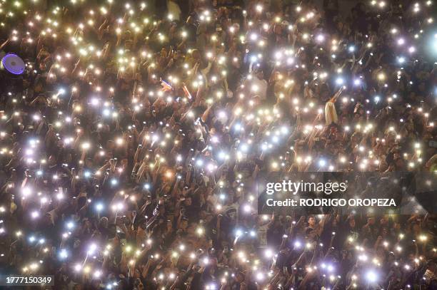 Pumas fans cheer on their team by lighting up with their cell phones during the Mexican Apertura 2023 tournament football match between Pumas and...