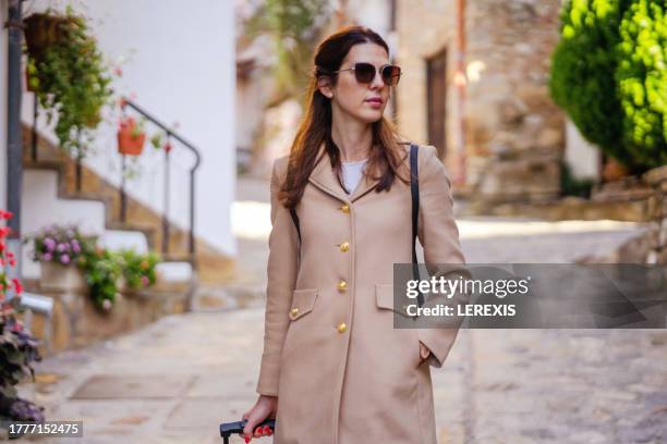 portrait of a female tourist on the streets of a european city - lerexis stock pictures, royalty-free photos & images