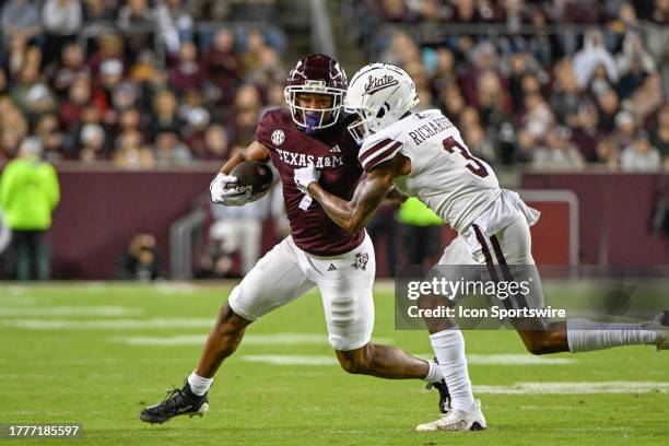 Texas A&M Aggies wide receiver Moose Muhammad III attempts to fight off a tackle attempt by Mississippi State Bulldogs cornerback Decamerion...