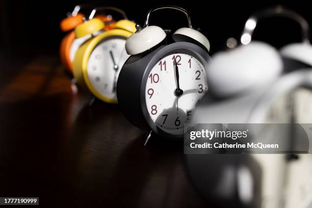 march of time concept: row of old-fashioned clocks - daylight saving time stock pictures, royalty-free photos & images