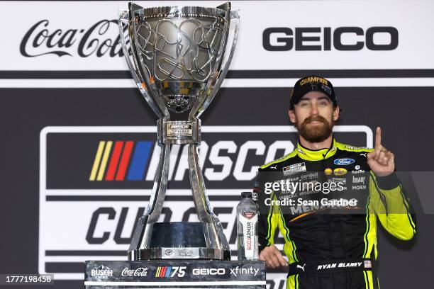 Ryan Blaney, driver of the Menards/Dutch Boy Ford, celebrates in victory lane after winning the 2023 NASCAR Cup Series Championship, finishing first...