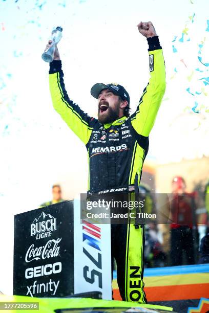 Ryan Blaney, driver of the Menards/Dutch Boy Ford, celebrates in victory lane after winning the 2023 NASCAR Cup Series Championship, finishing first...