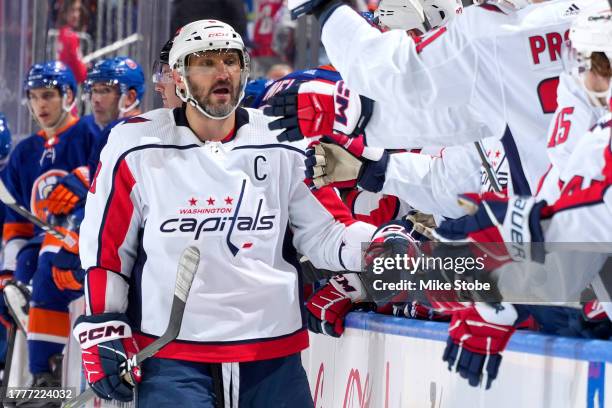 Alex Ovechkin of the Washington Capitals is congratulated by his teammates after scoring a goal against the New York Islanders during the third...