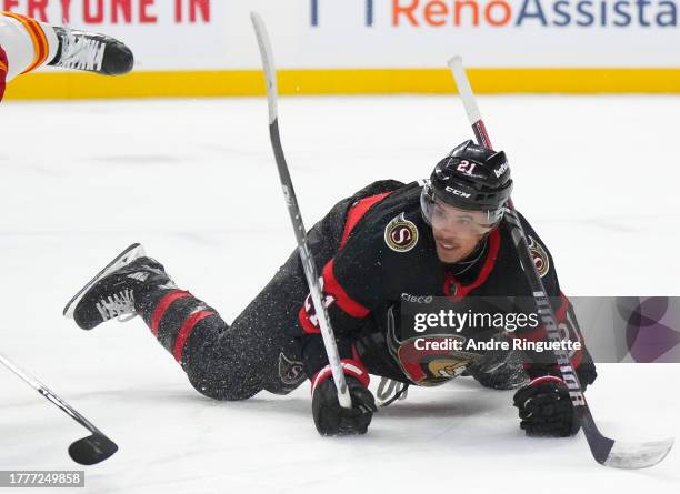 Mathieu Joseph of the Ottawa Senators falls to the ice after being tripped by Blake Coleman of the Calgary Flames at Canadian Tire Centre on November...