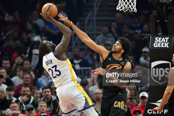 Draymond Green of the Golden State Warriors tries to shoot over Jarrett Allen of the Cleveland Cavaliers during the second quarter at Rocket Mortgage...