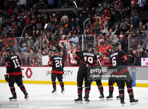 Drake Batherson, Matthew Highmore, Jakob Chychrun and Jacob Bernard-Docker of the Ottawa Senators salute the crowd after their teams' 4-1 win against...