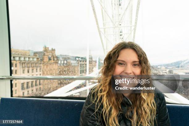 ferris wheel ride at edinburgh christmas market - rain face stock pictures, royalty-free photos & images