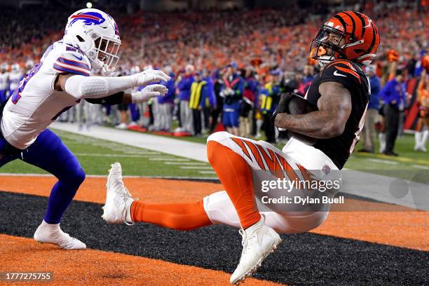 Irv Smith Jr. #81 of the Cincinnati Bengals catches a touchdown reception against Jordan Poyer of the Buffalo Bills during the first quarter at...