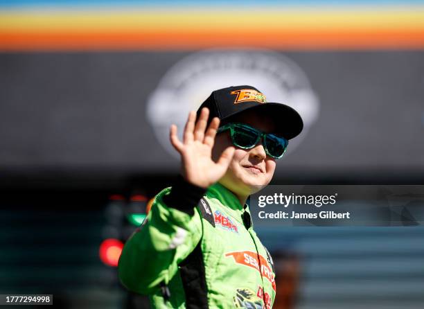 Brexton Busch, the son of NASCAR Cup Series driver, Kyle Busch, waves to fans as he walks onstage during driver intros prior to the NASCAR Cup Series...