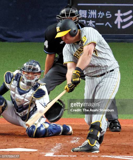 Sheldon Neuse of the Hanshin Tigers hits a three run home run in the 4th inning against Orix Buffaloes during the Japan Series Game Seven at Kyocera...