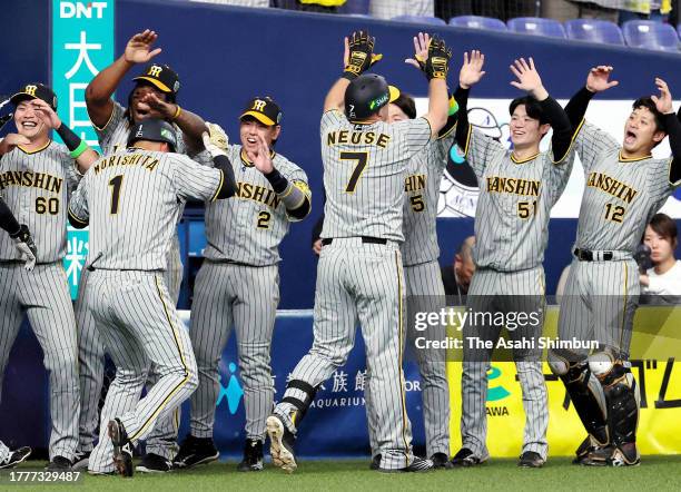 Sheldon Neuse of the Hanshin Tigers celebrates with teammates after hitting a three run home run in the 4th inning against Orix Buffaloes during the...