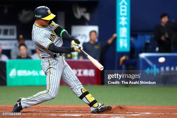 Shota Morishita of the Hanshin Tigers hits a RBI single in the 9th inning against Orix Buffaloes during the Japan Series Game Seven at Kyocera Dome...