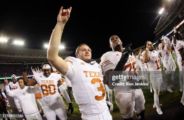 Quinn Ewers of the Texas Longhorns celebrates with teammates following the team's win over the TCU Horned Frogs at Amon G. Carter Stadium on November...