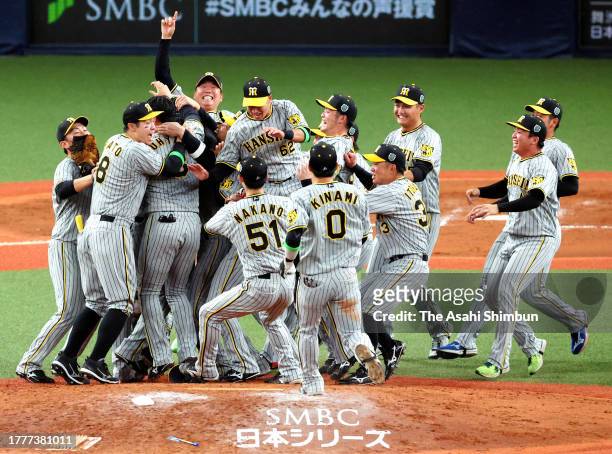 Hanshin Tigers players celebrate winning the Japan champions following the team's 7-1 victory in the Japan Series Game Seven at Kyocera Dome Osaka on...