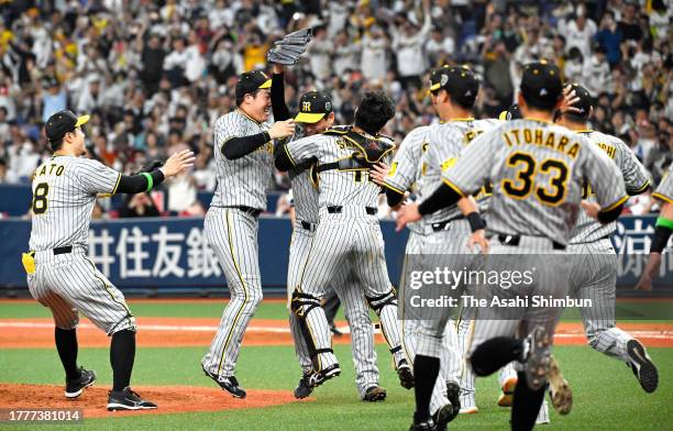 Hanshin Tigers players celebrate winning the Japan champions following the team's 7-1 victory in the Japan Series Game Seven at Kyocera Dome Osaka on...