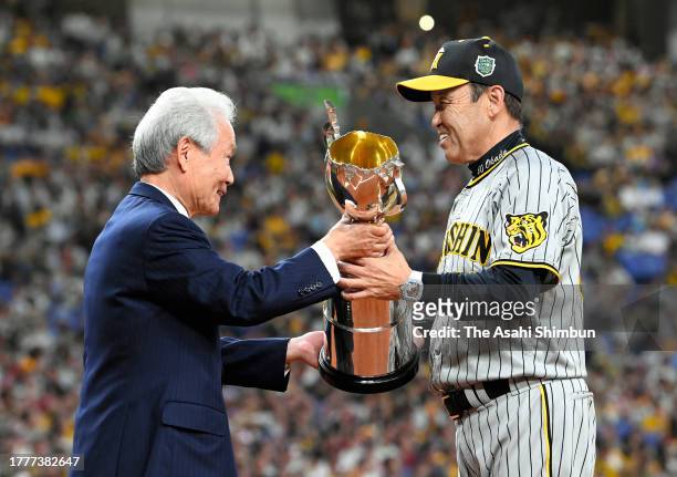 Head coach Akinobu Okada is presented the Japan Champions trophy following the team's 7-1 victory in the Japan Series Game Seven at Kyocera Dome...
