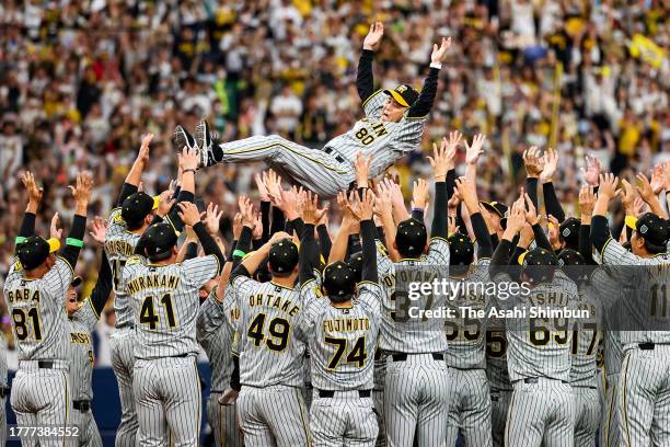 Head coach Akinobu Okada of the Hanshin Tigers is tossed into the air as they celebrate the Japan champions following the Japan Series Game Seven at...