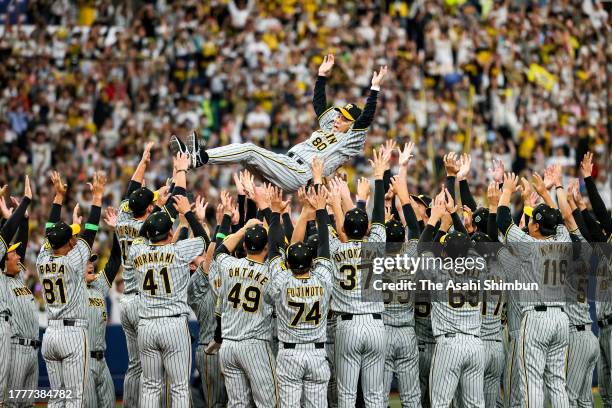 Head coach Akinobu Okada of the Hanshin Tigers is tossed into the air as they celebrate the Japan champions following the Japan Series Game Seven at...