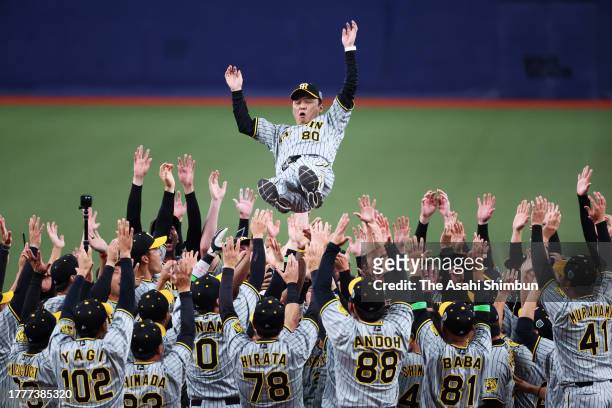 Head coach Akinobu Okada of the Hanshin Tigers is tossed into the air as they celebrate the Japan champions following the Japan Series Game Seven at...