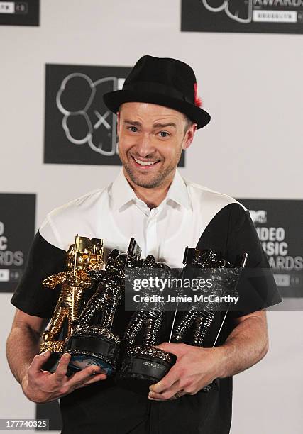 Justin Timberlake poses with Video of the Year award, Best Direction award, Best Editing award and Michael Jackson Video Vanguard award in the...