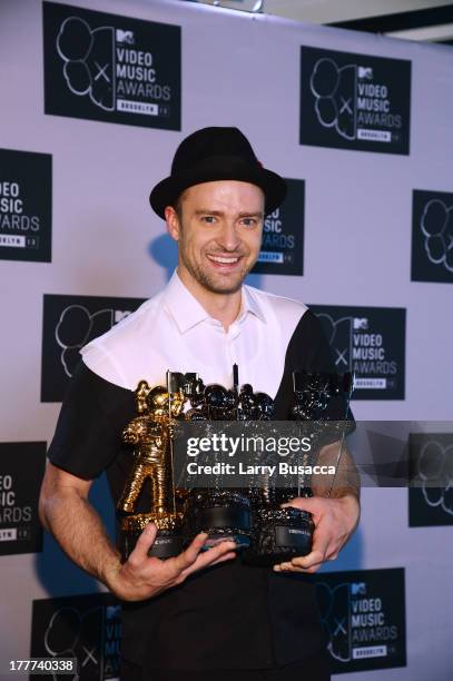 Justin Timberlake poses with Video of the Year award, Best Direction award, Best Editing award and Michael Jackson Video Vanguard award in the press...