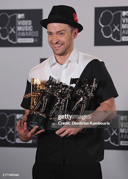 Justin Timberlake poses with Video of the Year award, Best Direction award, Best Editing award and Michael Jackson Video Vanguard award in the press...