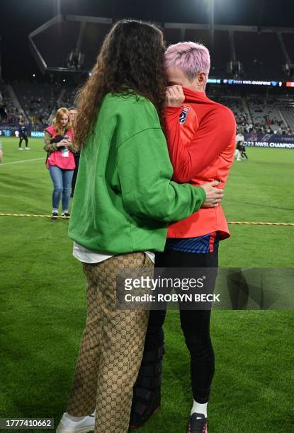 Reign's US midfielder Megan Rapinoe wears a boot on her right foot as she is comforted by partner former US basketball player Sue Bird after Gotham...