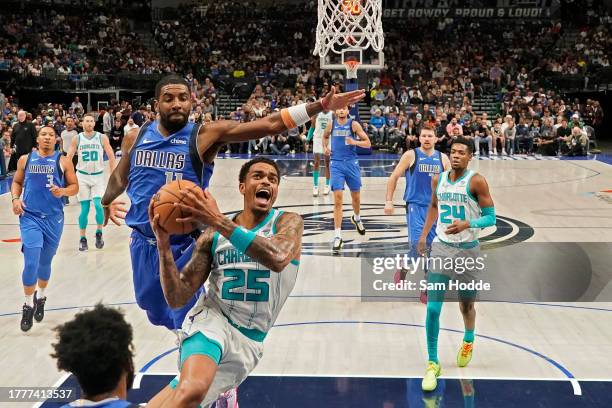 Washington of the Charlotte Hornets drives to the basket as Kyrie Irving of the Dallas Mavericks defends during the first half at American Airlines...