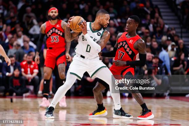 Dennis Schroder of the Toronto Raptors defends against Damian Lillard of the Milwaukee Bucks during the first half of their NBA game at Scotiabank...