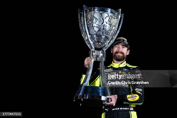 Ryan Blaney, driver of the Menards/Dutch Boy Ford, poses with the Bill France NASCAR Cup Series Championship trophy after winning the 2023 NASCAR Cup...