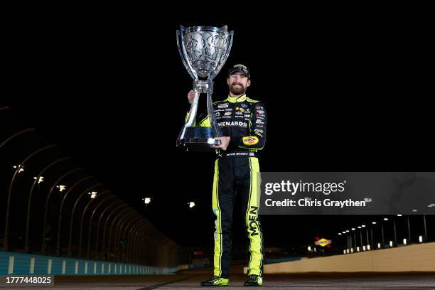Ryan Blaney, driver of the Menards/Dutch Boy Ford, poses with the Bill France NASCAR Cup Series Championship trophy after winning the 2023 NASCAR Cup...