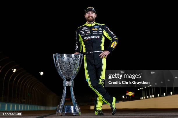 Ryan Blaney, driver of the Menards/Dutch Boy Ford, poses with the Bill France NASCAR Cup Series Championship trophy after winning the 2023 NASCAR Cup...